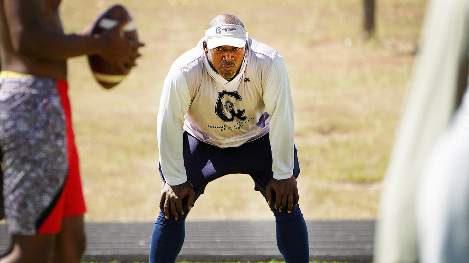 Former Dallas Cowboys quarterback Quincy Carter mentoring young athletes.