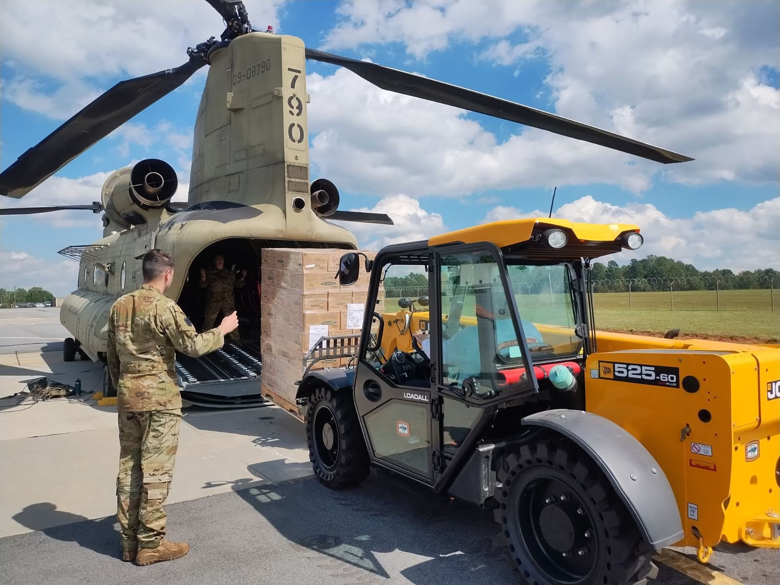 Emergency responders load supplies onto a helicopter for delivery to hospitals and affected areas in Western North Carolina after Hurricane Helene.