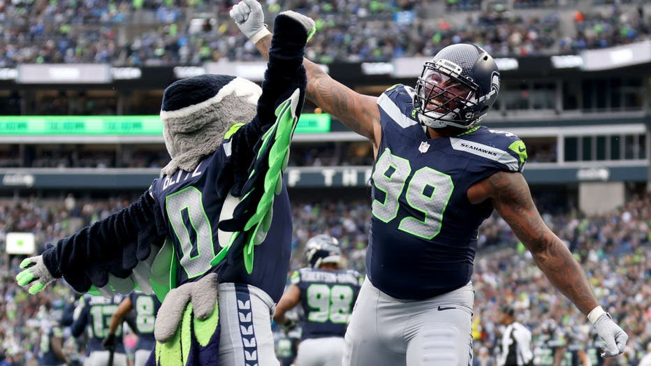 Seattle Seahawks player Leonard Williams and mascot Blitz