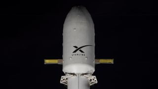 SpaceX rocket with Starlink logo on payload fairing.