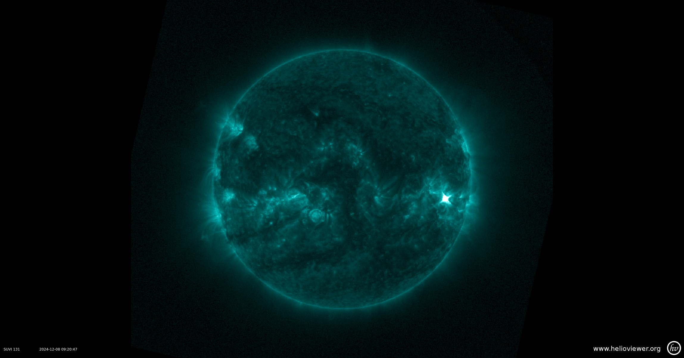 An extreme ultraviolet view of the Sun with loops of material and the bright flash of a solar flare on the right side