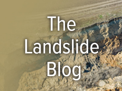 Image of a landslide partially covered with a transparent sand-colored overlay and the words “The Landslide Blog,” centered, in white